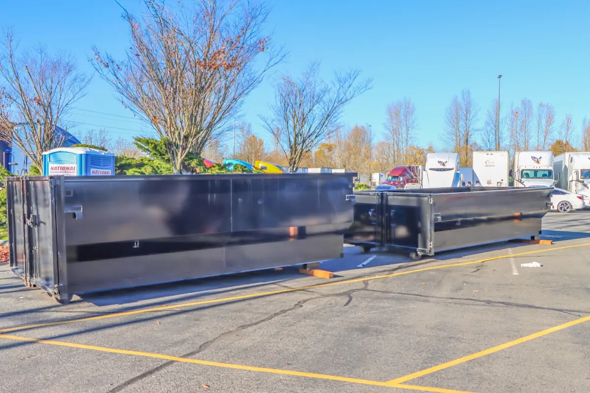 Professional dumpster rental service with roll-off container on residential driveway in Flowery Branch